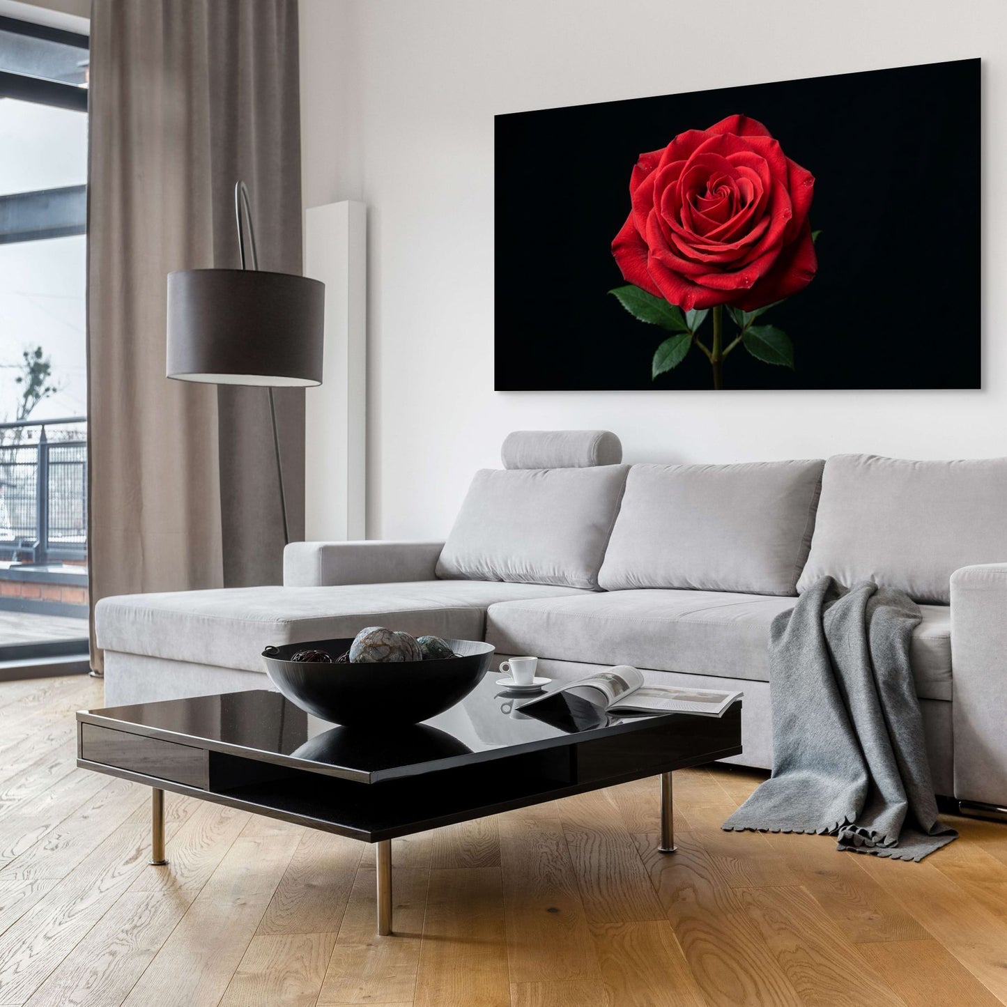 Modern living room with a gray sofa, black coffee table, and a large red rose painting on the wall.