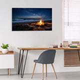 Beach scene with bonfire on wall above desk in home office.
