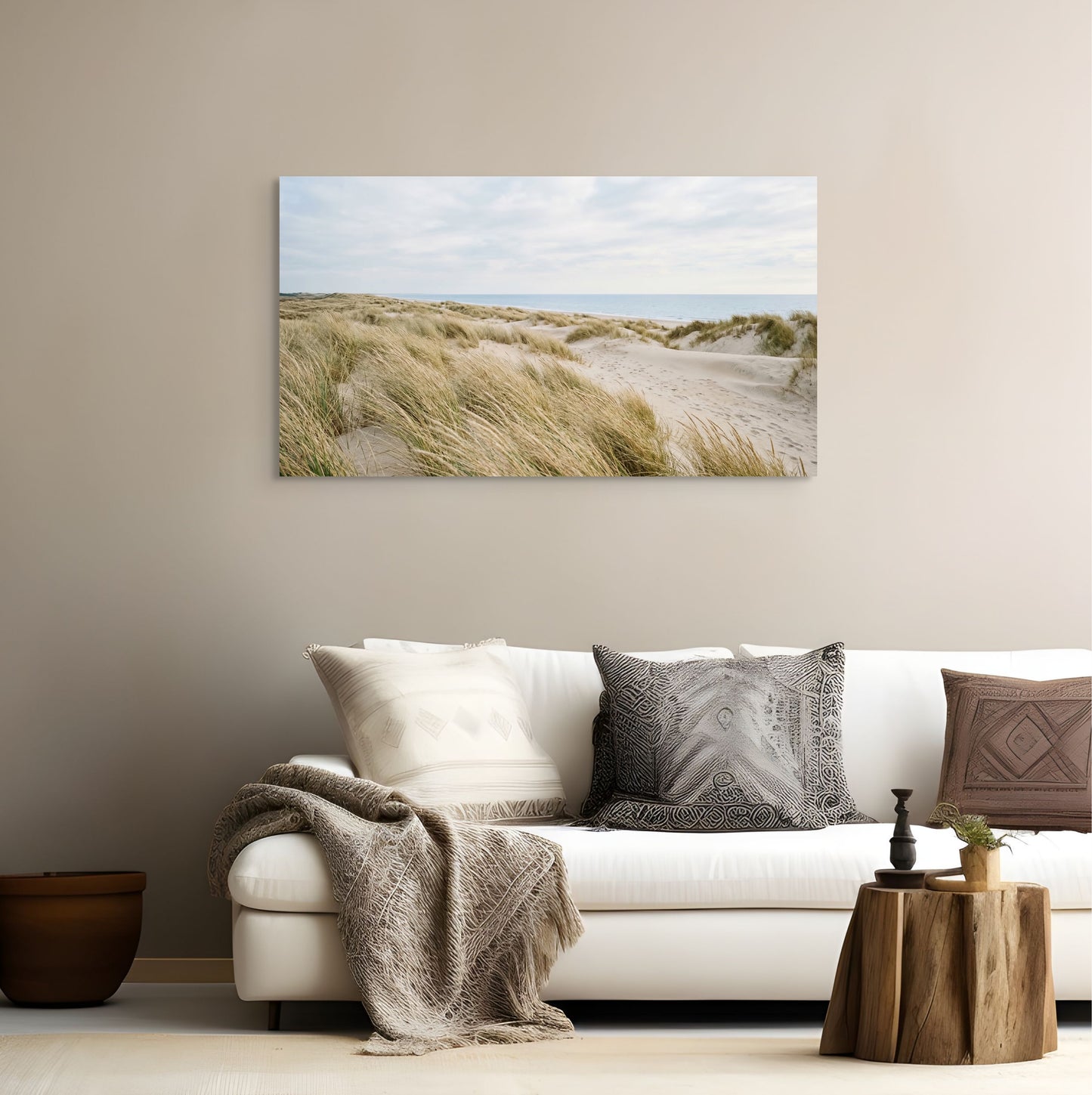 Living room with a white sofa, decorative pillows, and a large wall art of a beach scene.