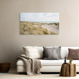 Living room with a white sofa, decorative pillows, and a large wall art of a beach scene.