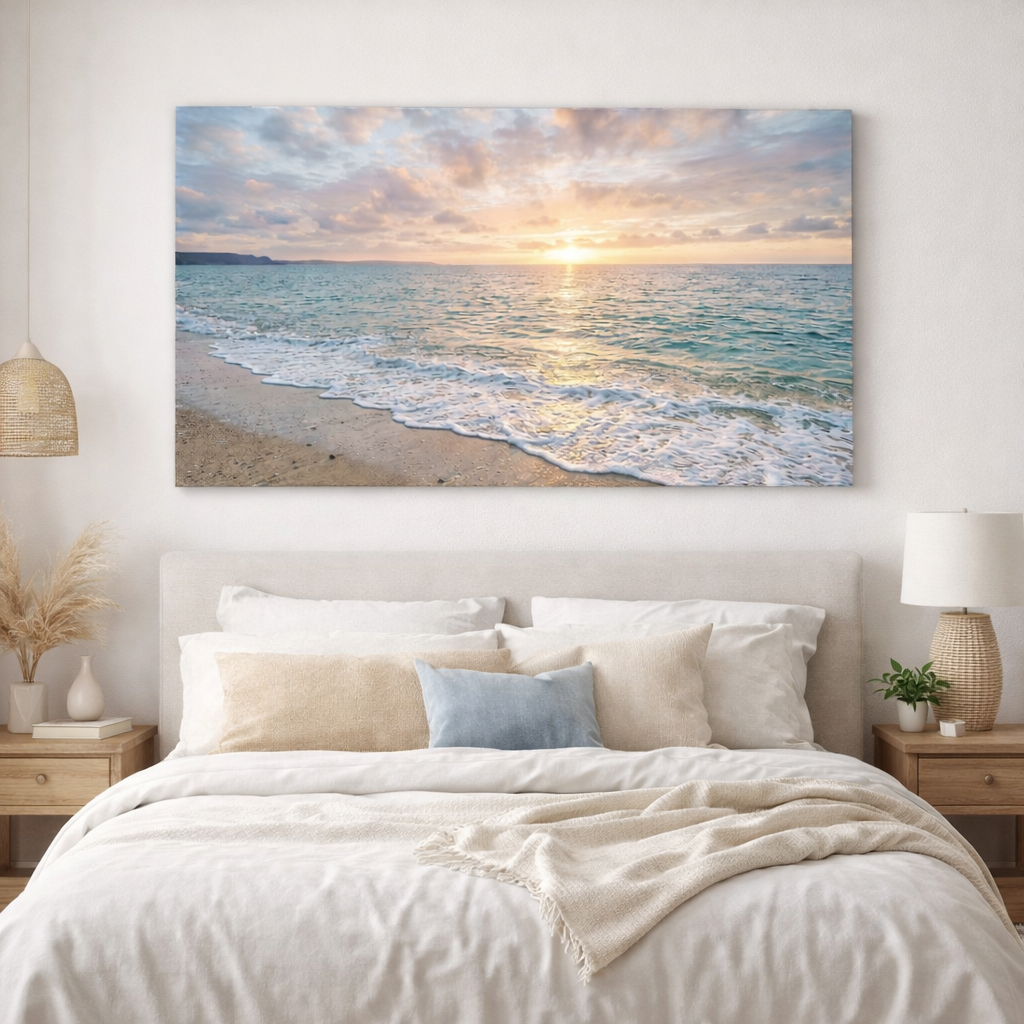 Beach sunset painting above a bed in a bedroom.