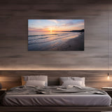 Beach sunrise canvas wall art with gentle ocean waves in modern bedroom.