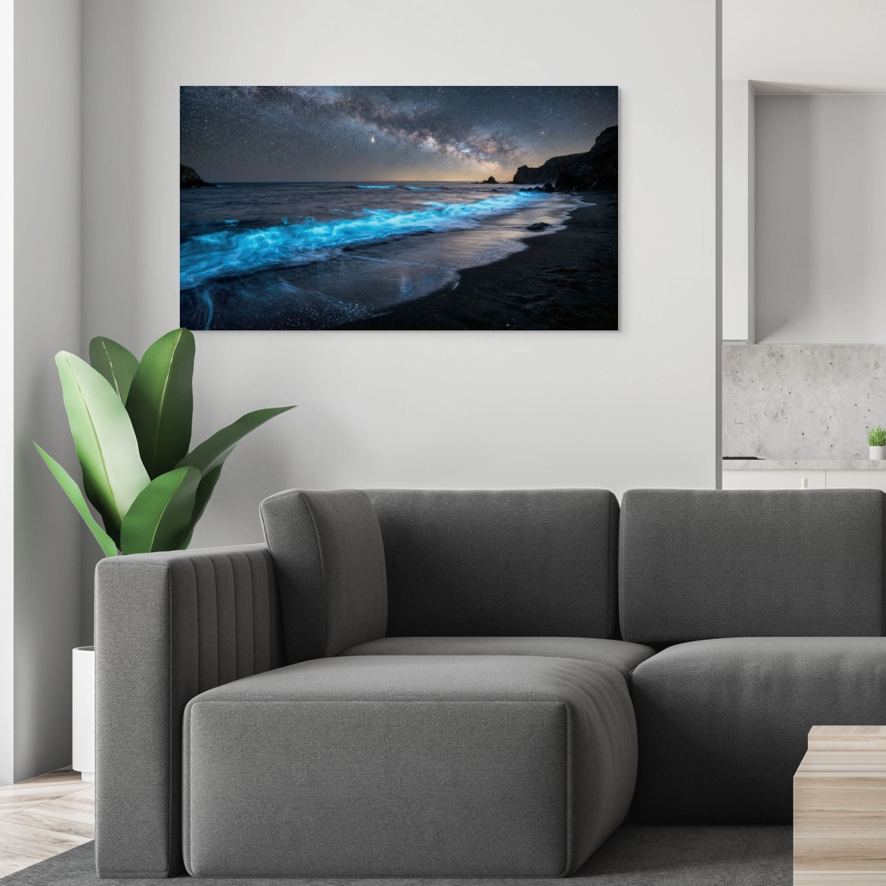 Modern living room with a gray sofa and a large wall-mounted canvas displaying a beach scene.