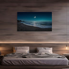Bedroom with a large TV displaying a beach scene with a crescent moon, above a bed with gray bedding.