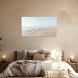 Bedroom with a large wall art of a beach scene above a bed.