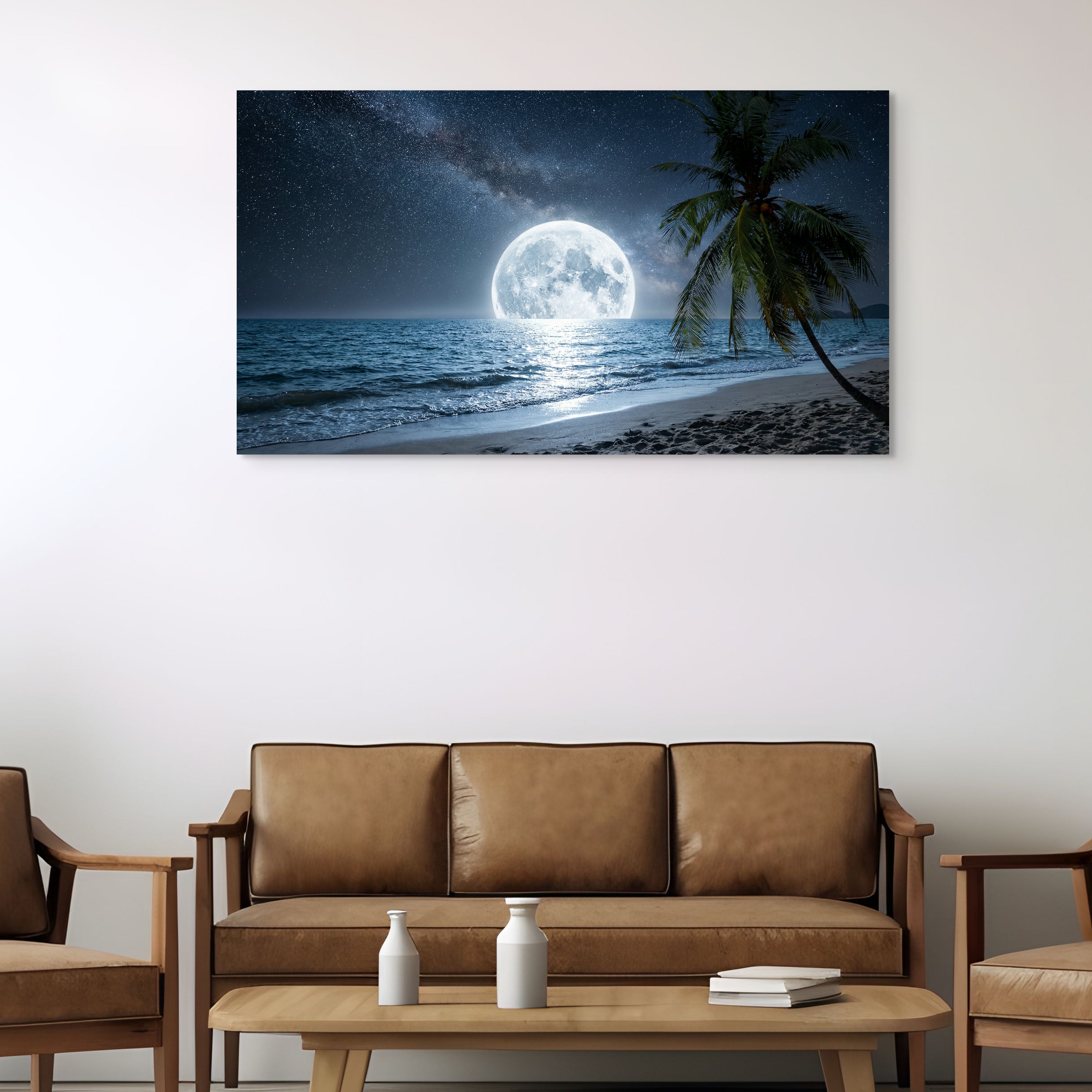 Beach scene with moonlit sky and palm tree on wall above brown sofa. Main image
