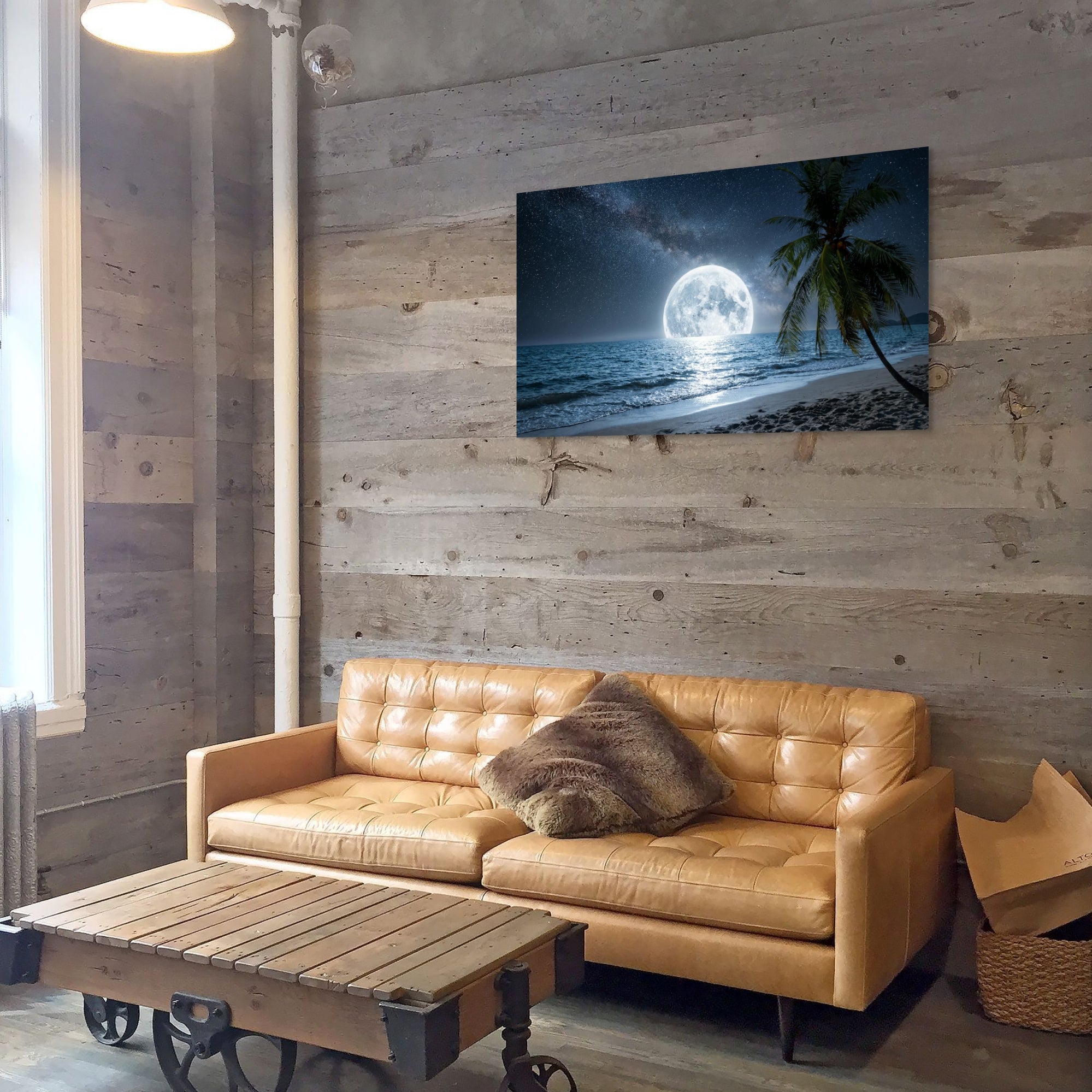 Living room with a brown leather sofa and a wall-mounted TV displaying a beach scene.