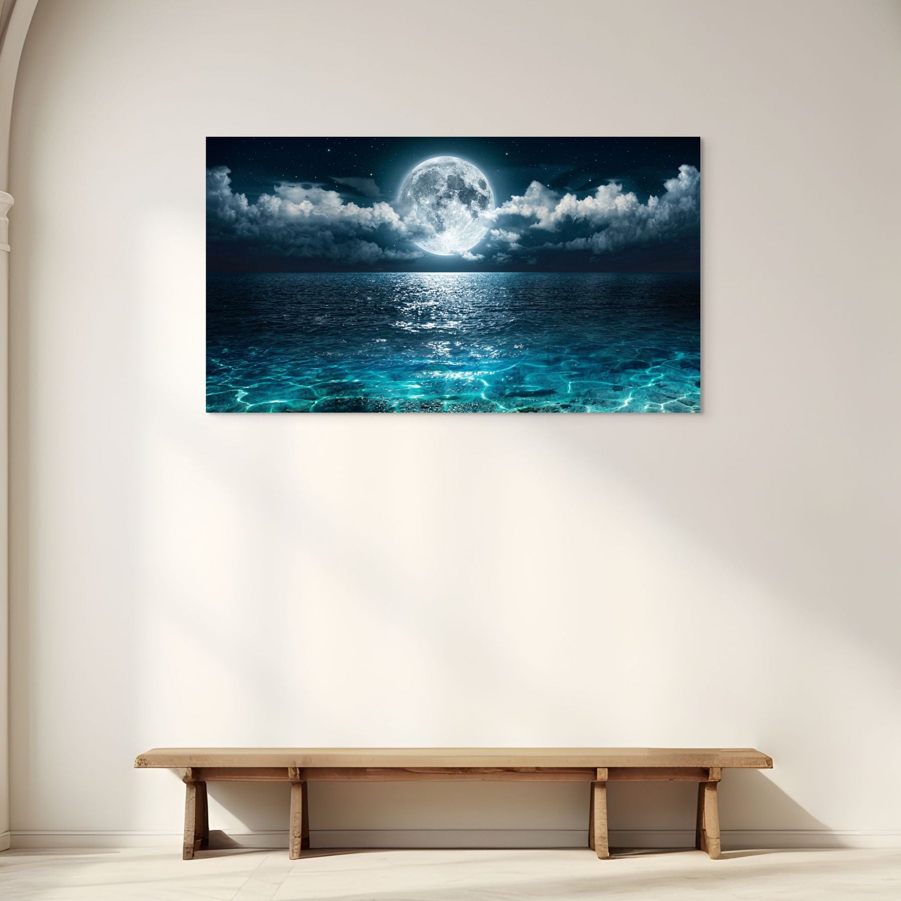 Wall art of a moonlit sea above a wooden bench in a minimalistic room.