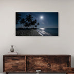 Framed artwork of a moonlit beach with palm trees above a wooden sideboard.