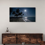 Framed artwork of a moonlit beach with palm trees above a wooden sideboard.