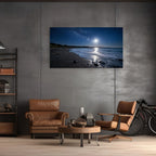 Modern living room with brown leather chairs, a coffee table, and a large canvas wall art displaying a beach scene at night.