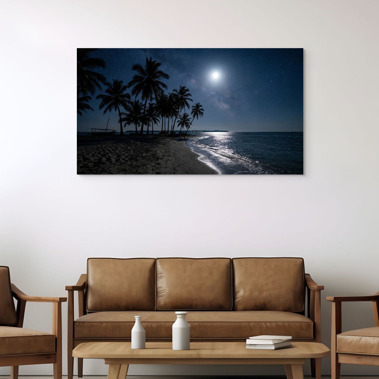 Framed artwork of a tropical beach scene with palm trees and moonlight above a brown sofa in a living room.