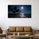 Framed artwork of a tropical beach scene with palm trees and moonlight above a brown sofa in a living room.