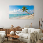 Tropical beach canvas wall art with palm trees and ocean in living room.
