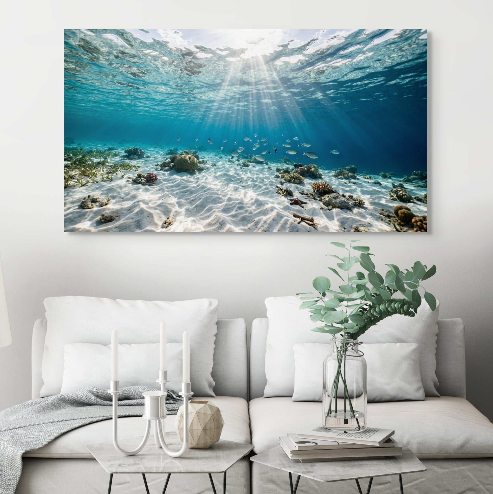 Underwater scene with sunlight filtering through water on a wall above a living room.