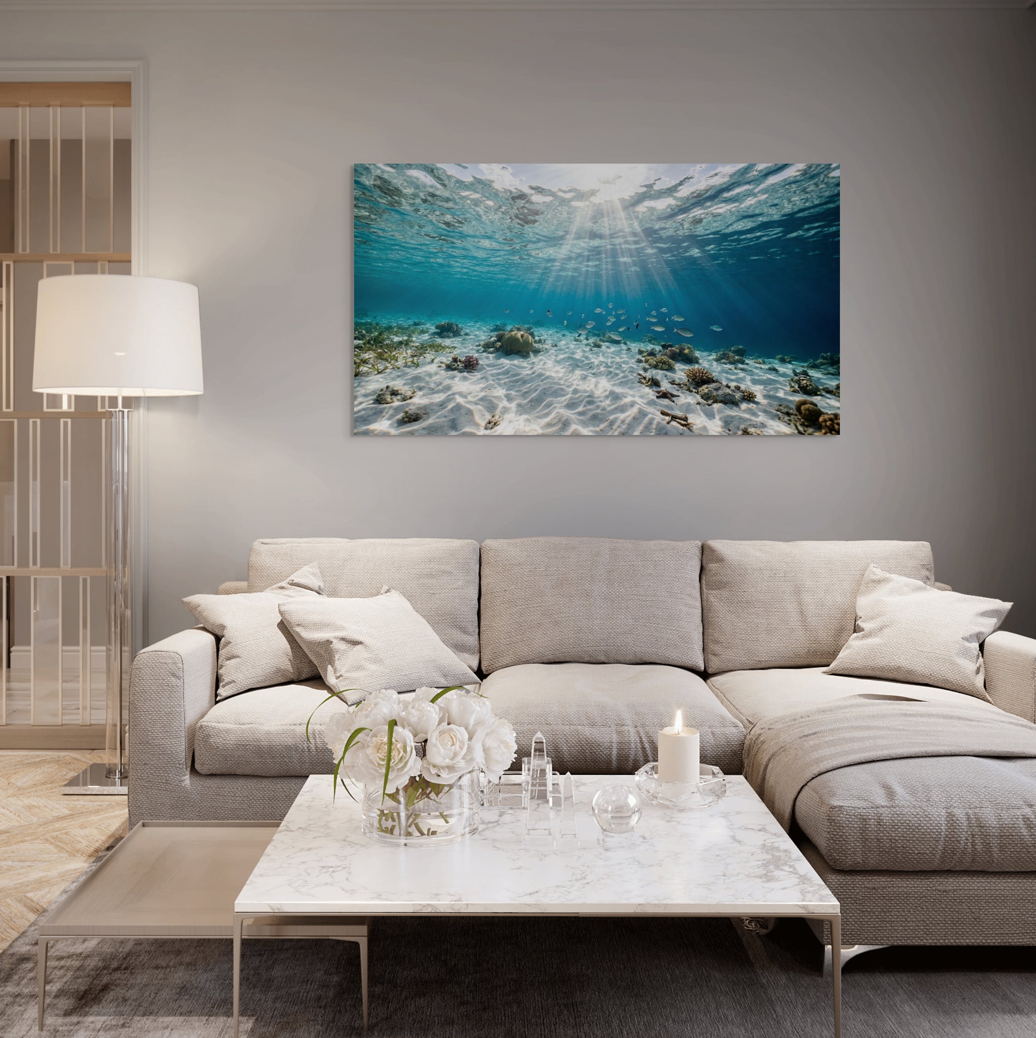 Living room with a sectional sofa, coffee table, and an underwater scene painting on the wall.
